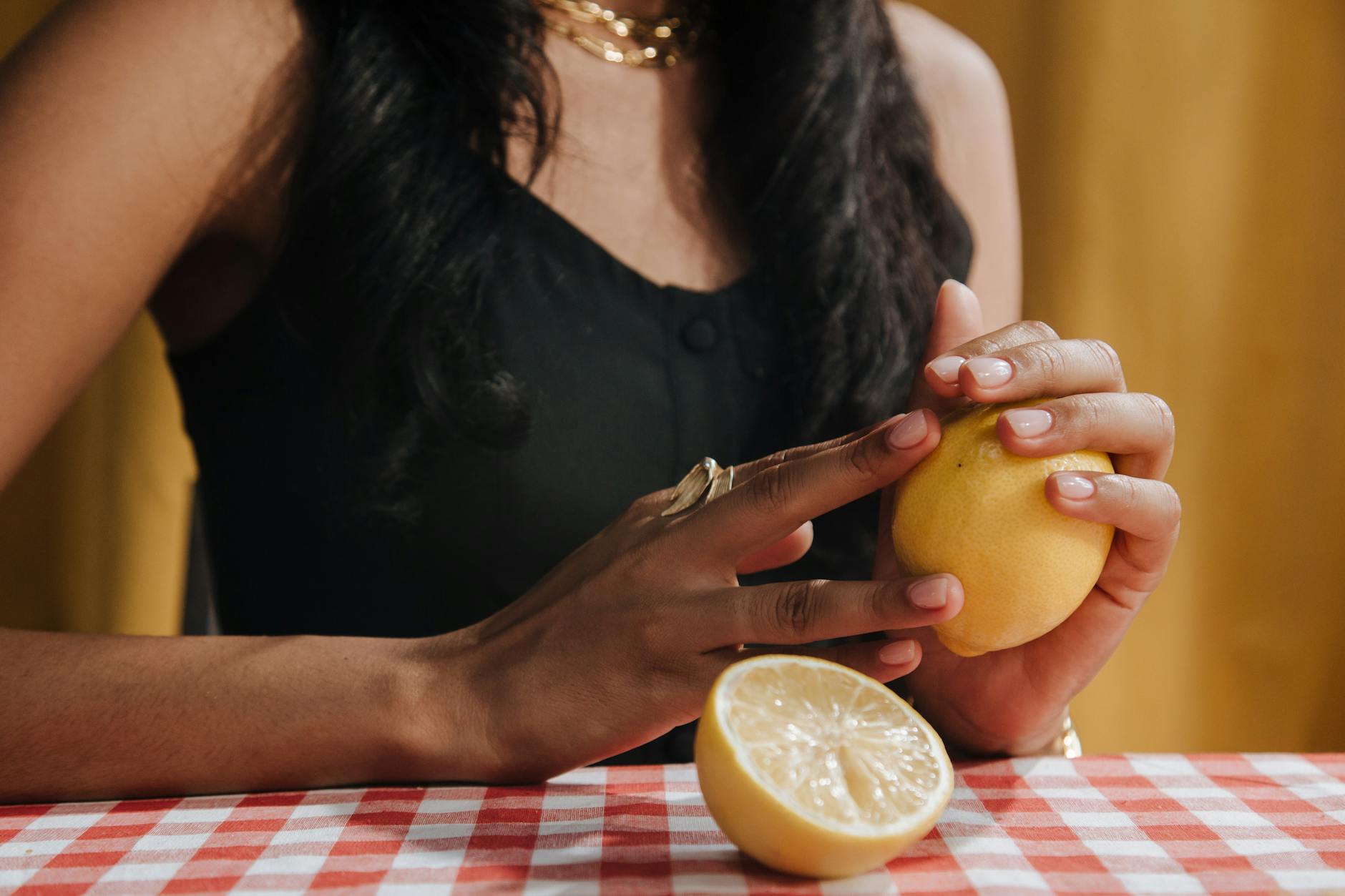 A woman holding a fresh lemon, representing the bright, concentrated sensation of clitoral stimulation