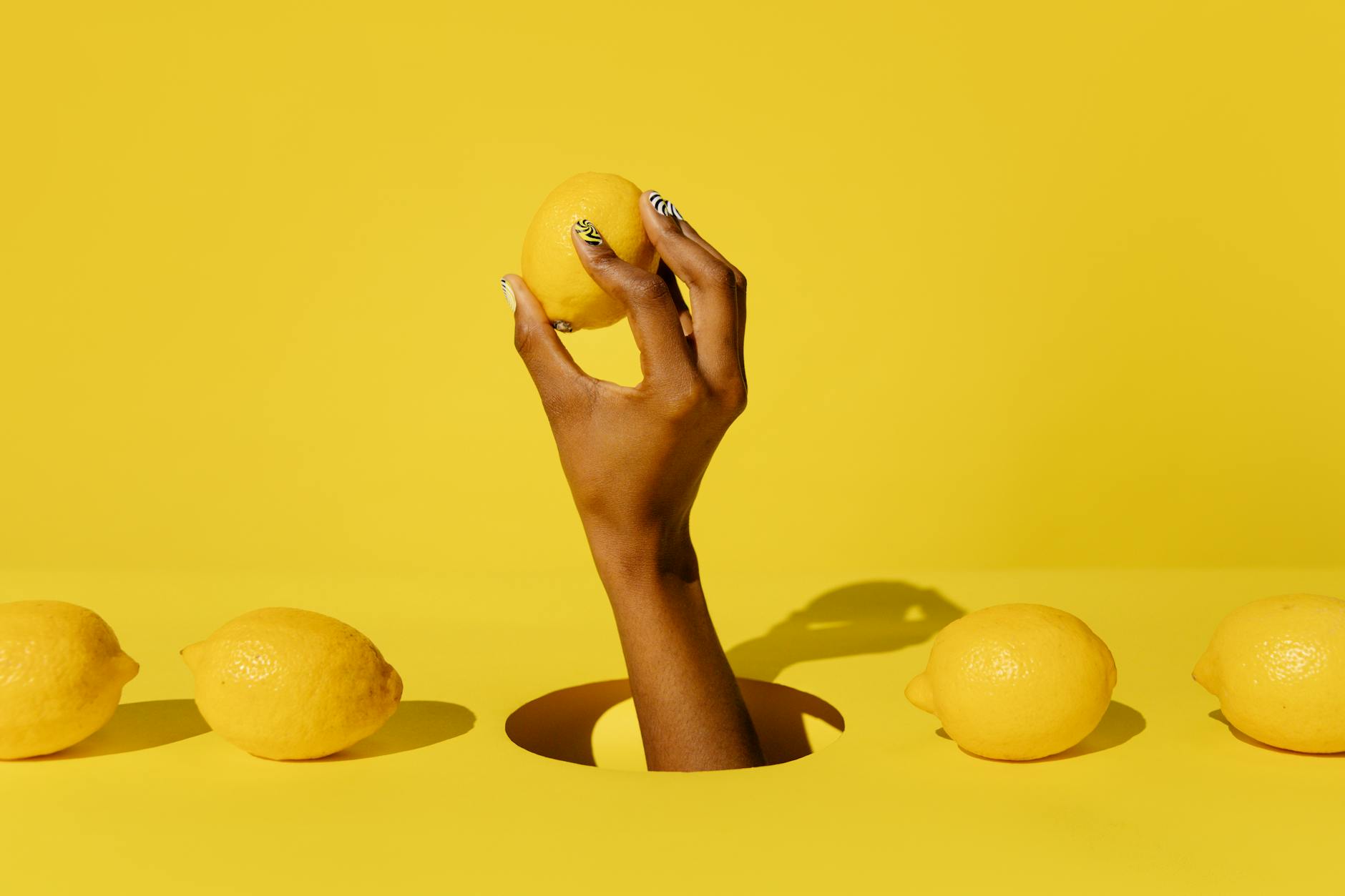 Yellow silicone vibrator with fresh fruit on bright background