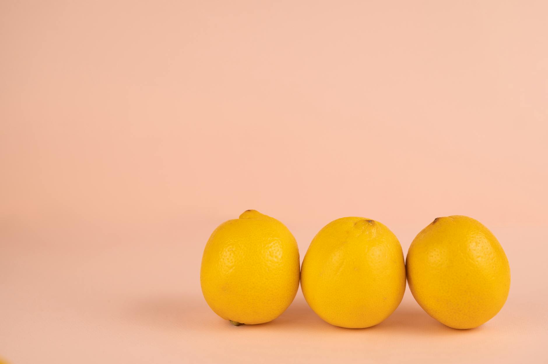 Bright ripe lemons arranged on a pastel background, symbolizing fresh approaches to postpartum wellness